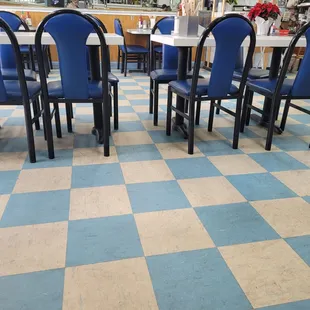 a blue and white checkered floor in a restaurant