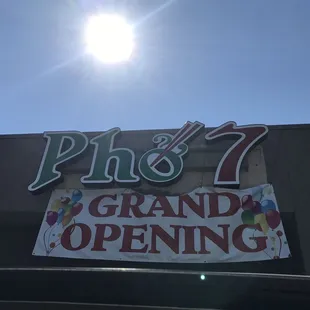 a sign for a grand opening