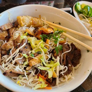 a bowl of noodles with meat and vegetables