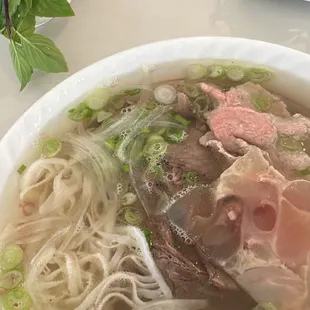 a bowl of soup with meat and noodles