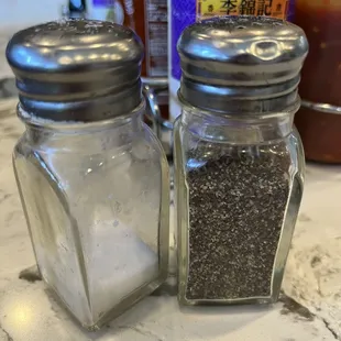 Dirty, sticky and not full salt and pepper shakers