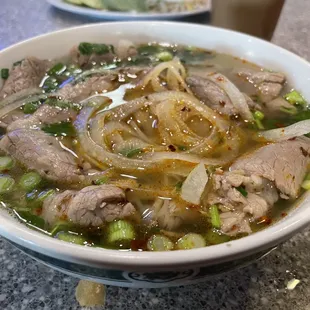 a bowl of soup with meat and vegetables