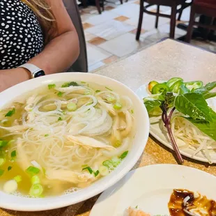 a plate of noodles and a bowl of soup