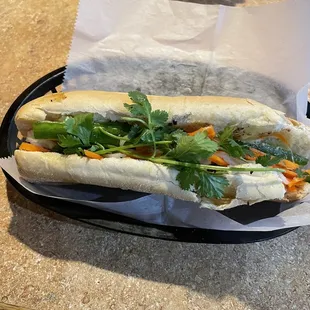 a sub sandwich on a tray on a table