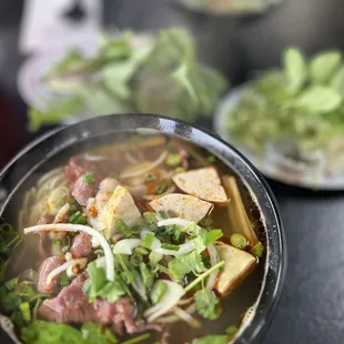 a bowl of soup with meat and vegetables