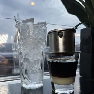 a cup of coffee next to a glass of water