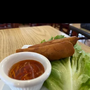 a hot dog and lettuce on a plate