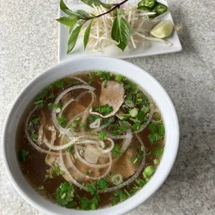 a bowl of soup and a plate of noodles