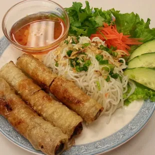 Egg rolls served with homemade fish dipping sauce with a bed of vermicelli noodles and vegetables