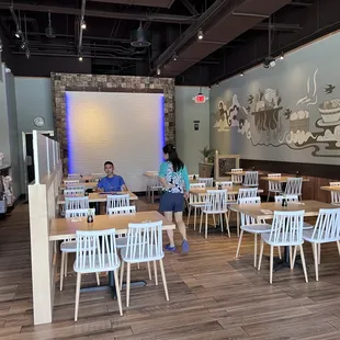 two people sitting at tables in a restaurant