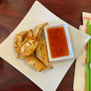 a plate of food with dipping sauce