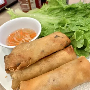 a plate of fried spring rolls and lettuce