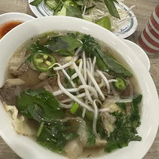 Small pho with brisket and meatballs with garnishing jalepenos, sprouts, and herbs.  Pho gau, bo vien, tho nho, Banh nho.