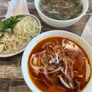 Bun Bo Hue (bottom bowl) $13.99 &amp; Pho Tai (top bowl) $12.50