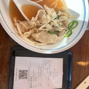 a bowl of soup and chopsticks