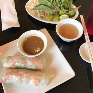 Spring rolls app brought out with pho fixings and soup/sauce for combo plate.