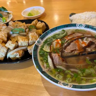 a bowl of soup and a plate of tofu