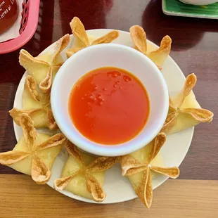 a bowl of dipping sauce on a plate