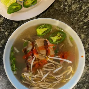 a bowl of soup and a plate of vegetables