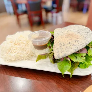 a sandwich and noodles