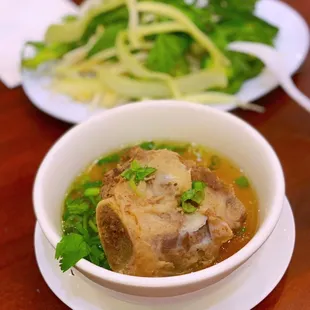 a bowl of soup and a plate of salad