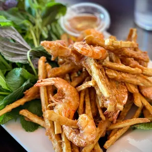a plate of french fries and a salad