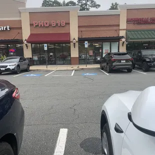 a parking lot with cars parked in front of it