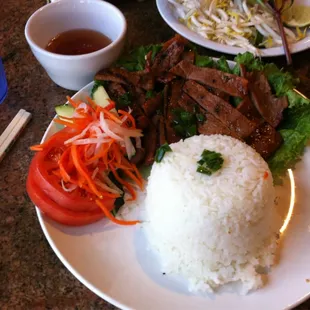 Marinated Pork with rice and vegetables with lots of flavor and a side of fish sauce