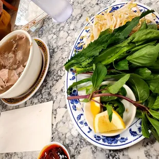 a plate of noodles and a bowl of soup