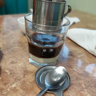a cup of coffee and a spoon on a table