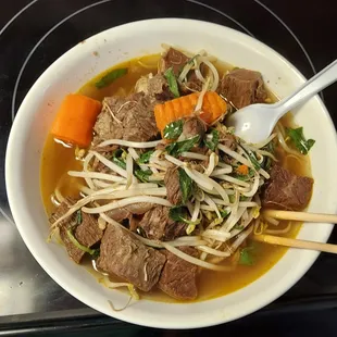 a bowl of beef and noodles