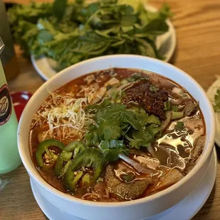 a bowl of soup and a plate of salad
