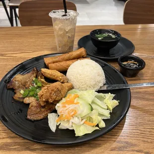 R1. Grilled Pork Chop, Fried Chicken Wing and Egg Roll over Rice Combo Plate