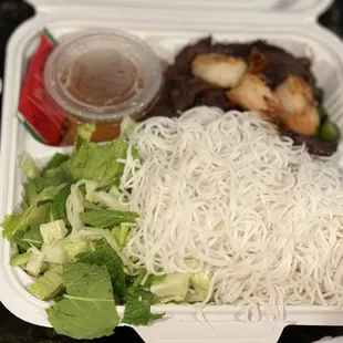 a container of noodles and meat