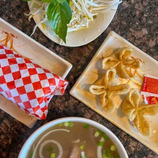 a bowl of soup and a plate of fried dumplings