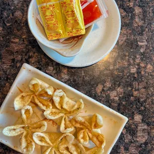 a plate of banana chips and a bowl of chips