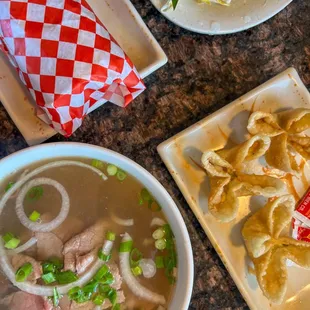 a bowl of soup and a plate of dumplings