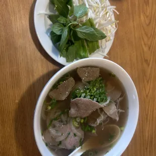 Special beef pho soup with the condiments on the side