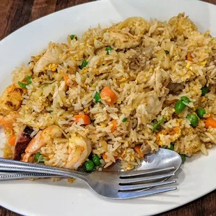  a plate of fried rice with shrimp and peas