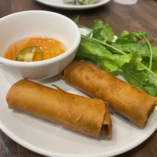  two spring rolls and a bowl of soup