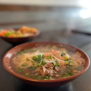 a bowl of soup and a bowl of noodles