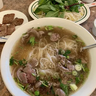 Large 1a (rare filet) pho and a side of grilled pork (on the small plate in the background)