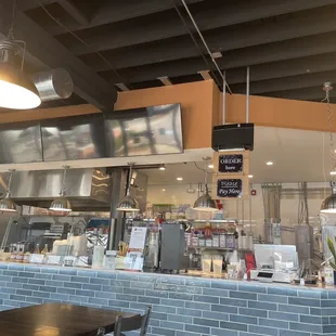 a restaurant counter with a television above it