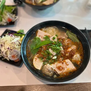 a bowl of soup with meat and vegetables