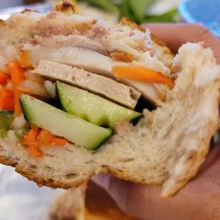 a person holding a sandwich