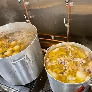 two pots of soup on a stove