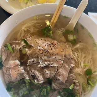 a bowl of soup with meat and vegetables