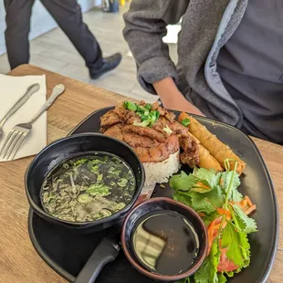 Rice plate with pork and egg rolls