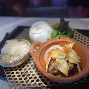 a bowl of food and chopsticks