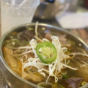 a bowl of soup and a drink
